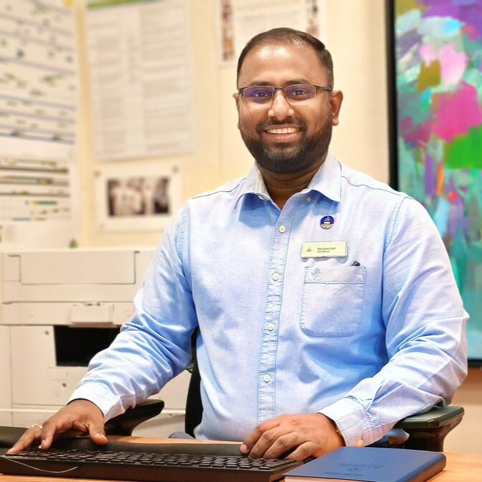 HR Manager working at computer in onboard office, supporting crew recruitment, training, employee relations and HR administration on a cruise ship
