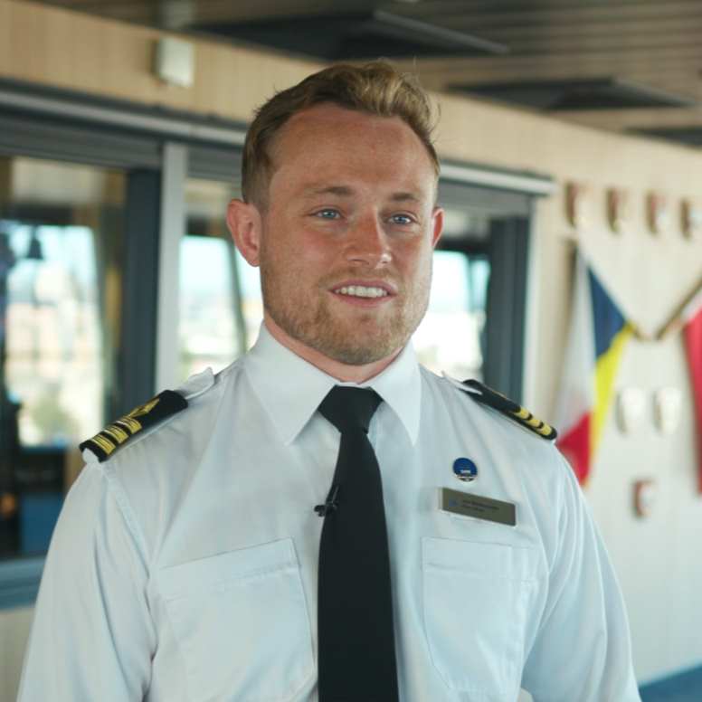 Deck Officer working onboard a P&O Cruises ship, standing on the bridge wing in uniform. The image represents maritime careers at sea, including navigation, ship operations, leadership, and officer career development opportunities with P&O Cruises for qualified seafarers and aspiring deck officers.