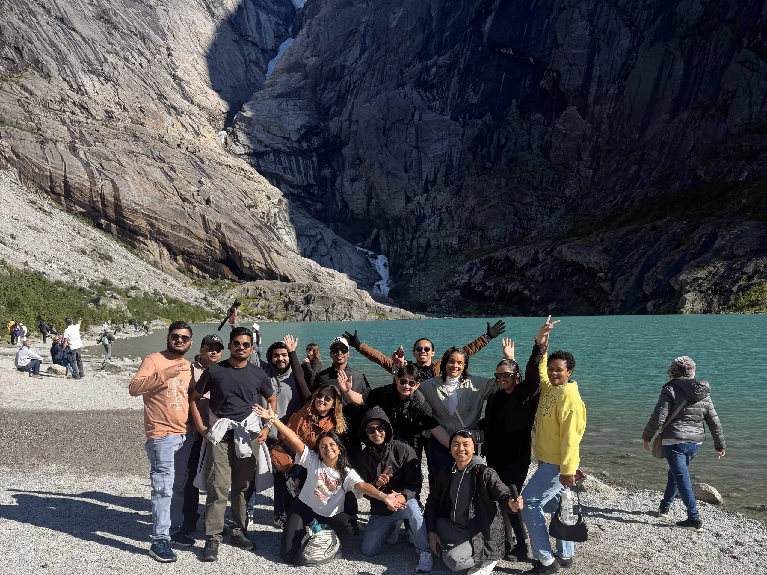 Arvia crew members gather beside a glacier lake in Norway during a crew excursion, creating shared experiences and memorable moments ashore.